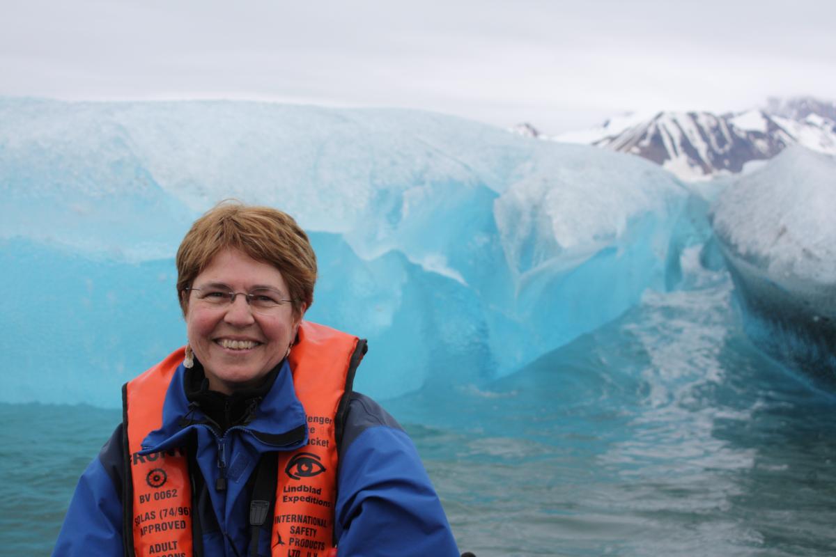 Jane Lubchenco in front of a white and blue iceberg