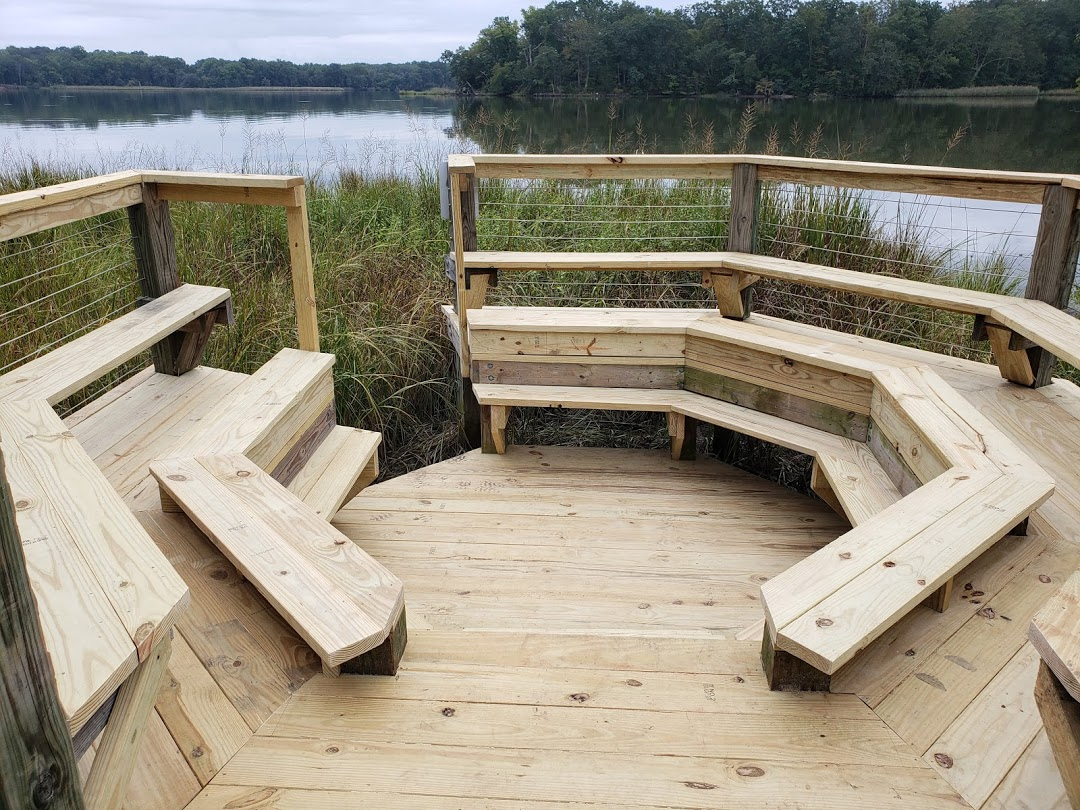 octagonal wooden sitting area in marsh overlooking river