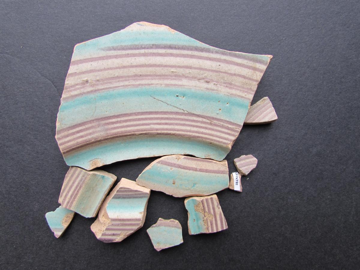 Many sherds of blue and purple ceramic