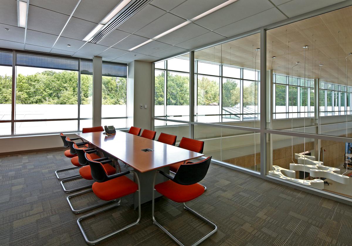 Mathias conference room with large windows and 10 orange chairs around a rectangular table