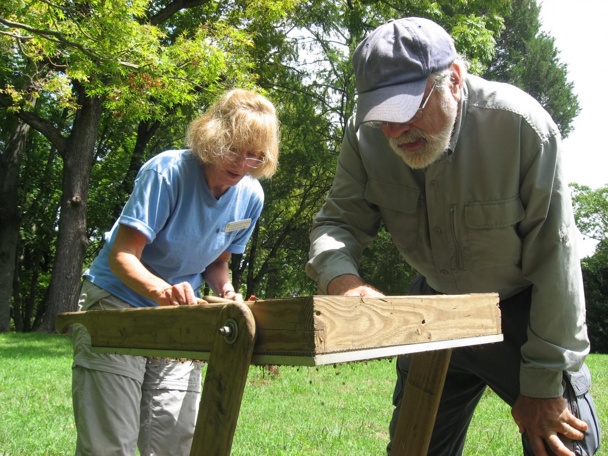 Scientist and volunteer look at screen