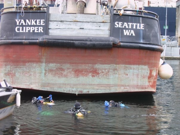 Ian Davidson, Gail Ashton, and Gregory Ruiz preparing to conduct a survey of a fishing boat in Ketchikan, AK. 