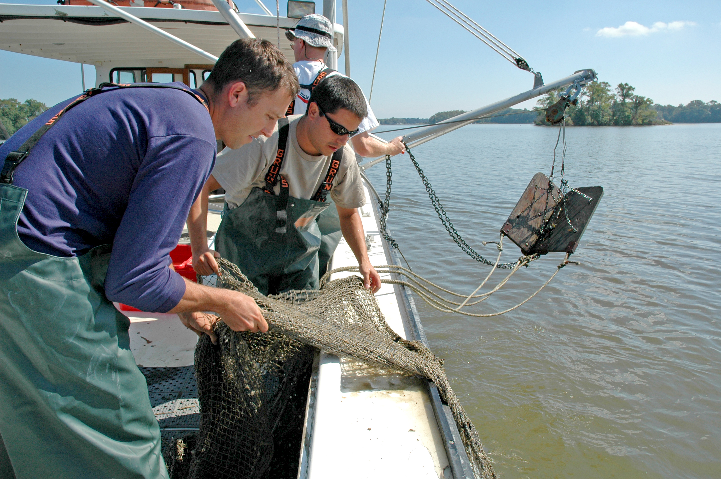 Scientists on boat with trawl net