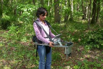 Rehanna Chaudhri with Portable Canopy LIDAR in forest