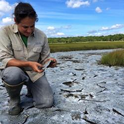 Keryn Gedan kneels on salt pan