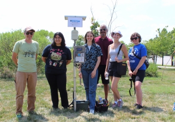 Breathe Baltimore team gather and pose for a photo withe the first deployed air sensor.