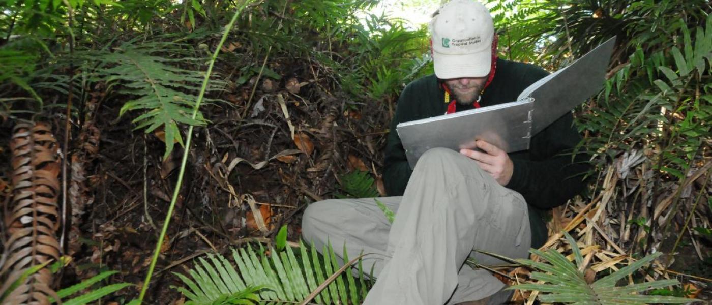 Researcher recording orchid distribution data