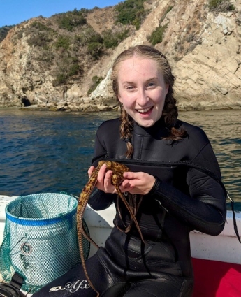 Holding up a female Octopus bimaculatus off the coast of Catalina, California