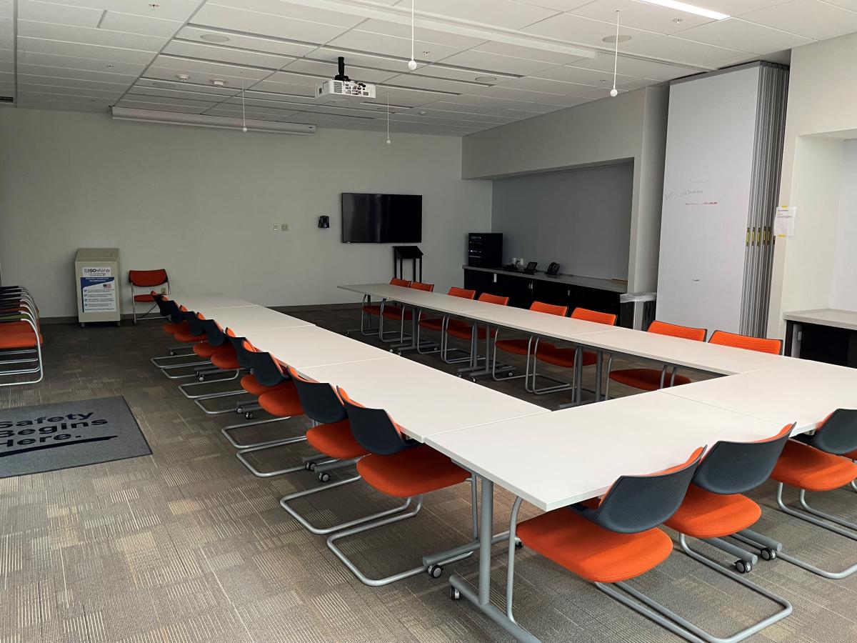 Mathias conference room with 2 rectangular tables with 12 orange chairs each